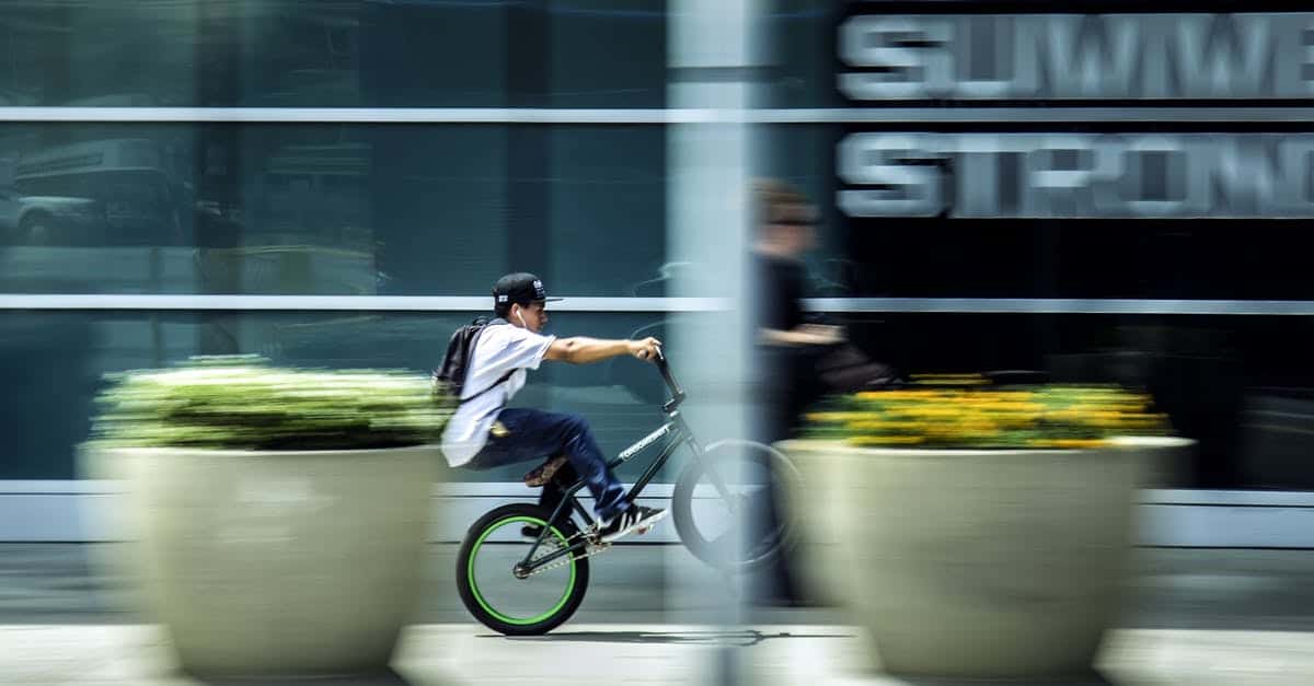 A man riding a bike down the street