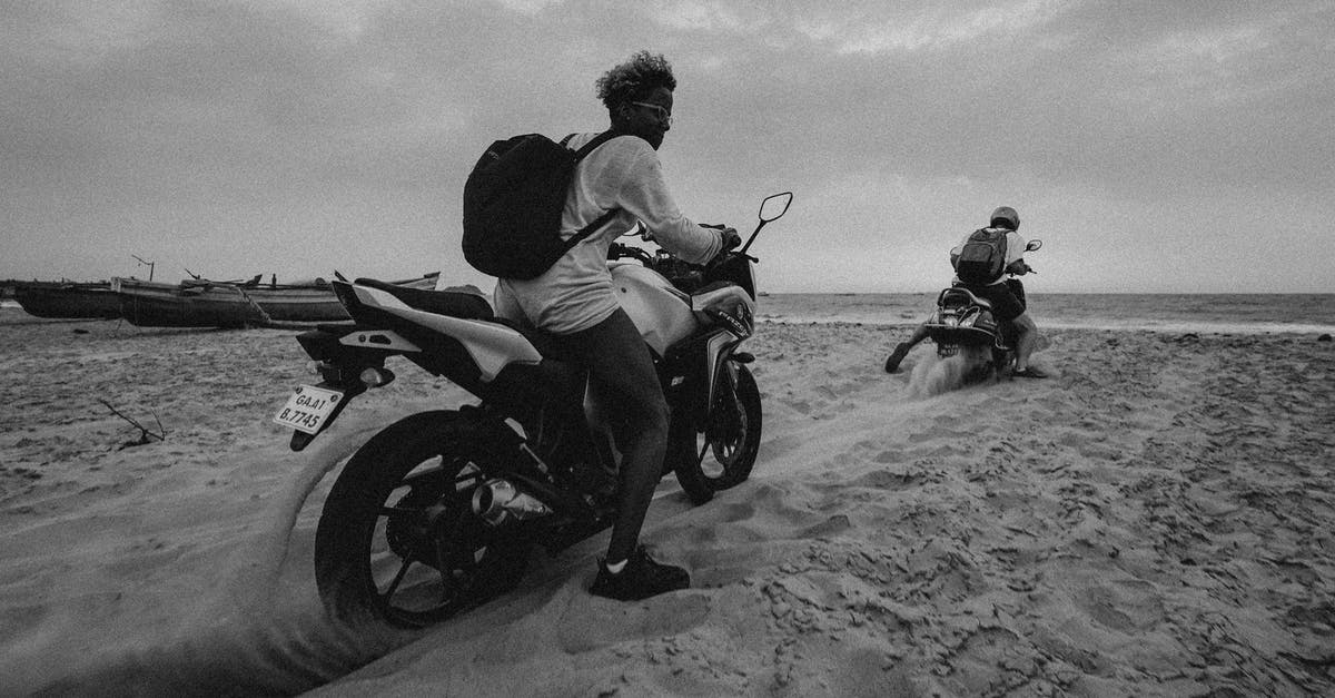 A man riding a motorcycle on a beach