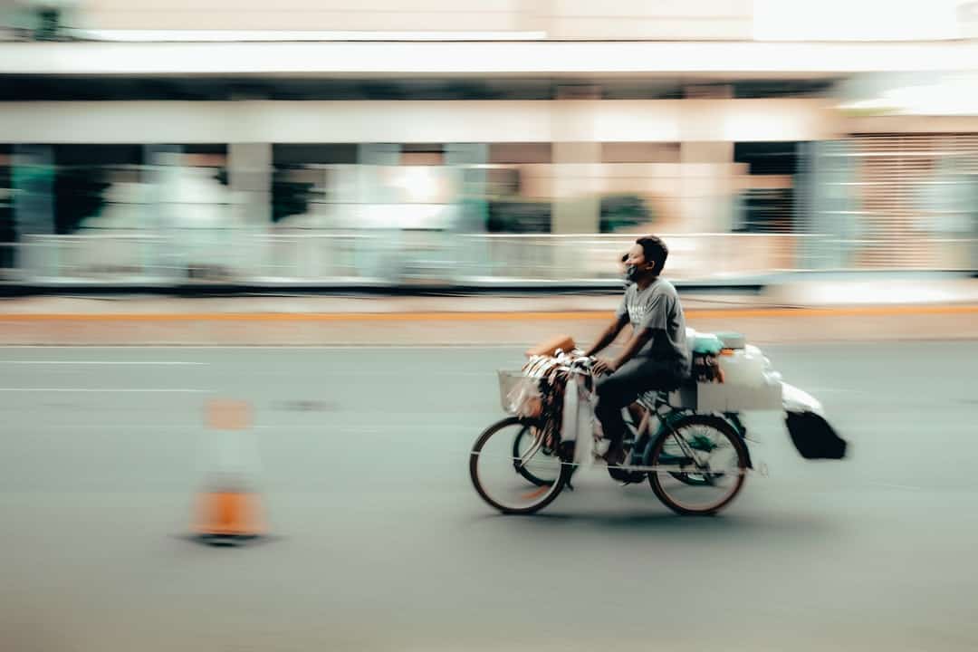 A person riding a bicycle down the street